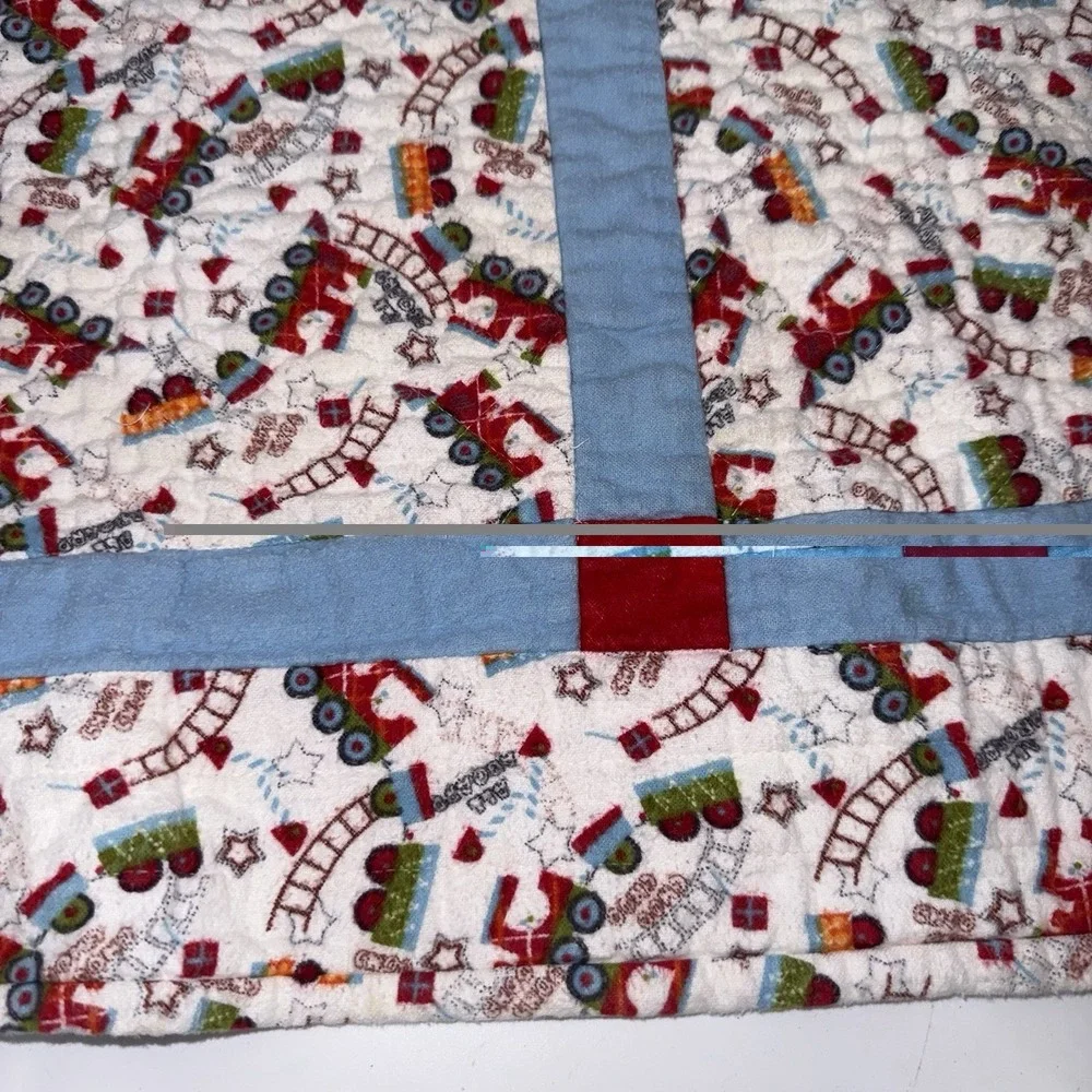 Vtg Baby Quilt Of Trains Print bordered by blue sashing and red cornerstones